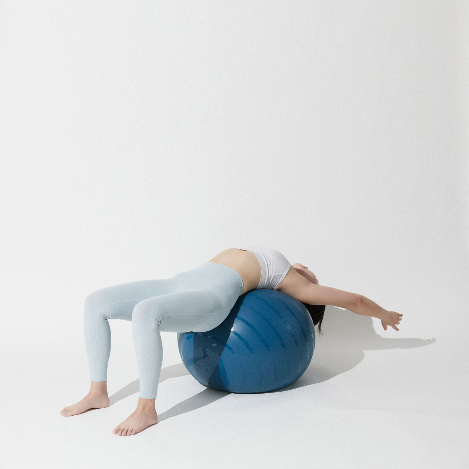A Line Pilates class in progress in a bright, minimal reformer studio